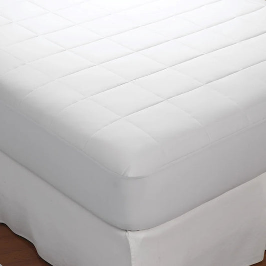 White quilted mattress cover on a bed